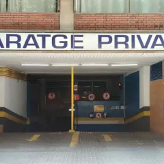 Entrada al parking nn Rocafort Barcelona. Señal de garaje privado con flechas amarillas indicando la dirección.
